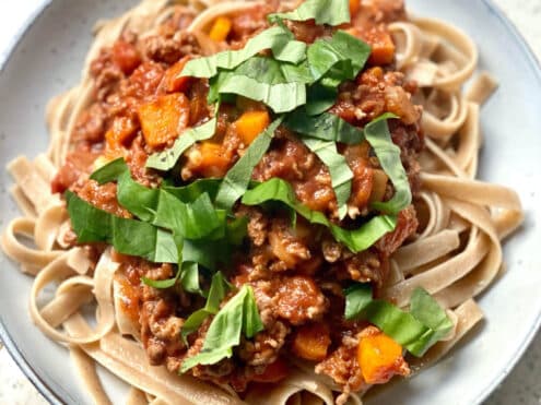 A plate of bolognese sauce served on zucchini noodles; another recipe to promote gut health.