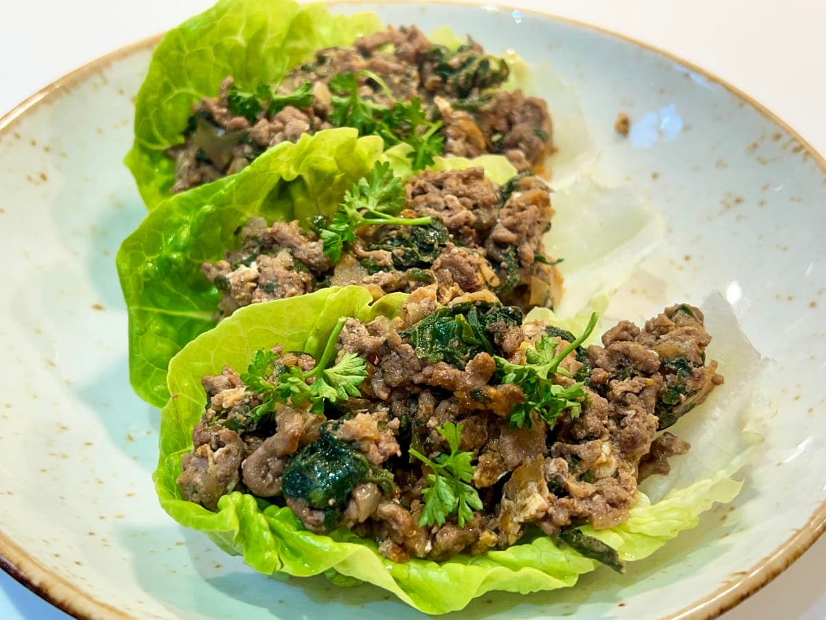 ground mince cooked in spices served in lettuce boats and topped with parsley