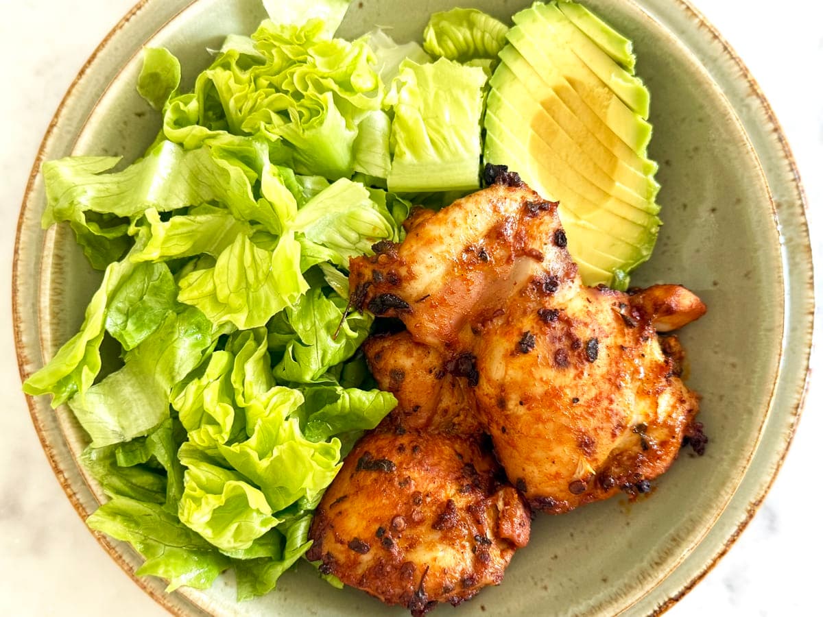Mexican Marinated Chicken with salad and an avocado.
