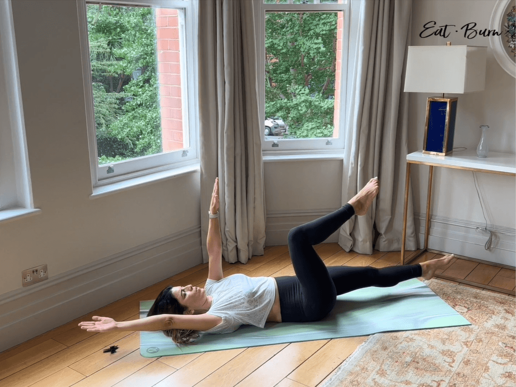 Screenshot of Yalda Alaoui midst exercise on a green mat by the window in her home.
